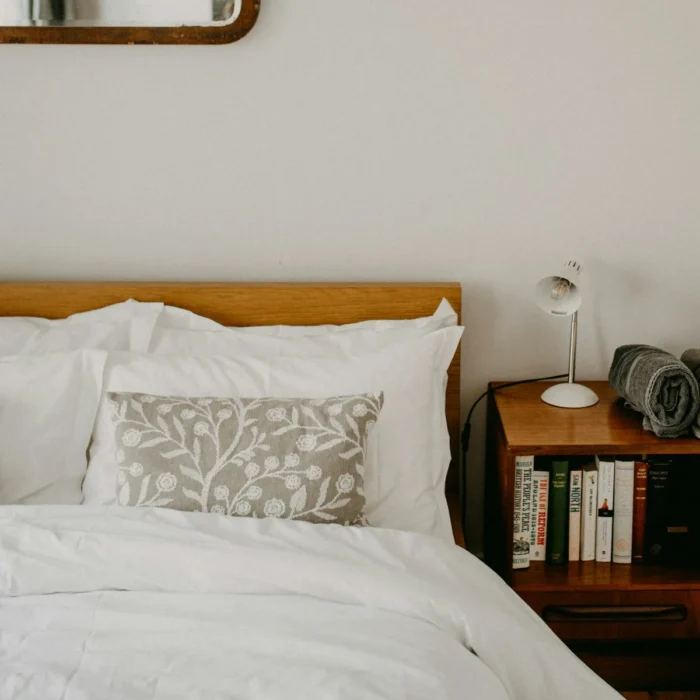 Ivory duvet cover set on a wooden bed shown to scale in a cosy bedroom